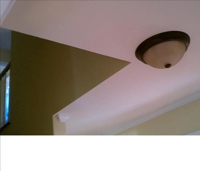 ceiling with white drywall and tan walls