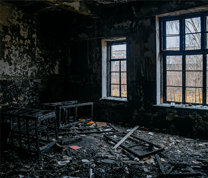 a fire damaged room with debris everywhere